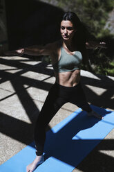 Woman practicing yoga in light and shadow - LJF00001