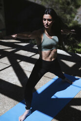 Woman practicing yoga in garden stock photo