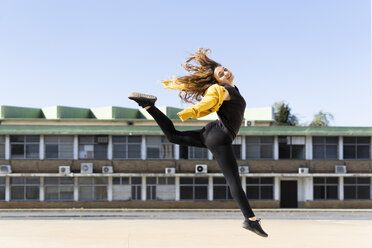 Happy teenage girl jumping outdoors - ERRF01402