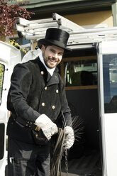 Porträt eines lächelnden Schornsteinfegers an seinem Lieferwagen - MAEF12889