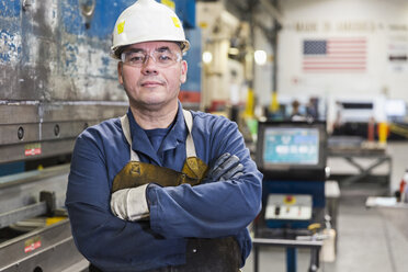 Serious Hispanic worker posing in factory - BLEF04452