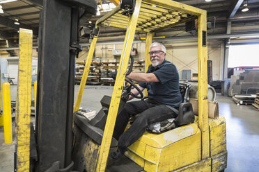 Caucasian worker driving forklift in factory - BLEF04457