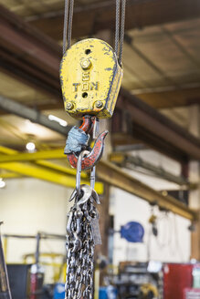 Pulley and chain hanging in factory - BLEF04478