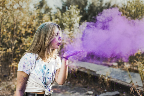 Girl blowing Holi powder colours, Germany stock photo