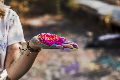 Girl holding Holi powder colours, Germany stock photo