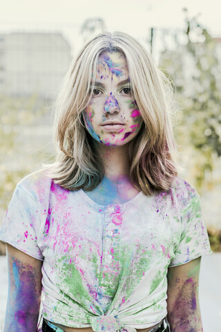 Gir Holi powder colours in her face, Germany stock photo