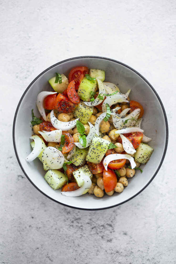 Salad with cucumbers chickpeas onion cherry tomatoes basil