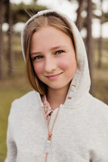 Portrait of smiling girl wearing hoodie - NMS00303