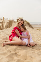 Two girls hugging on the beach - NMS00309