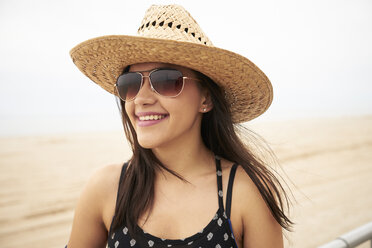 Mixed Race woman smiling on beach - BLEF04787