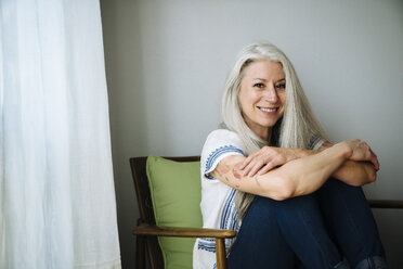 Caucasian woman sitting in armchair - BLEF04917