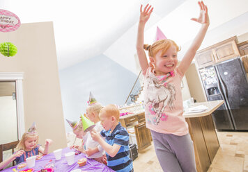 Caucasian girl wearing party hat cheering - BLEF04964