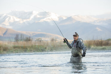 Caucasian man fly fishing in river - BLEF04969