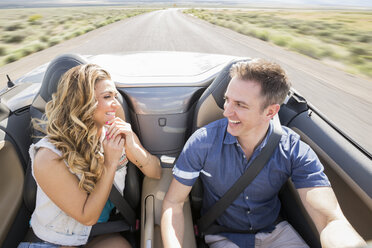 Caucasian couple driving in sports car - BLEF05017