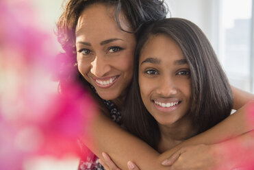 Smiling mother and daughter hugging - BLEF05031