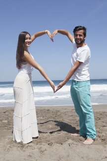 Royalty-Free photo: Couple's hands forming heart gesture