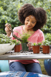 Black woman gardening at table outdoors - BLEF05110