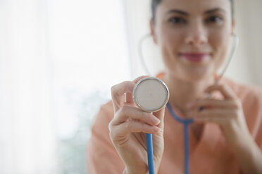 Caucasian nurse listening with stethoscope - BLEF05141