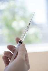 Hand holding syringe - BLEF05173