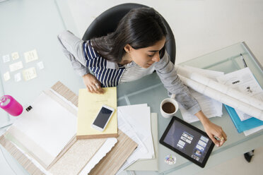 Indian businesswoman using digital tablet in office - BLEF05178