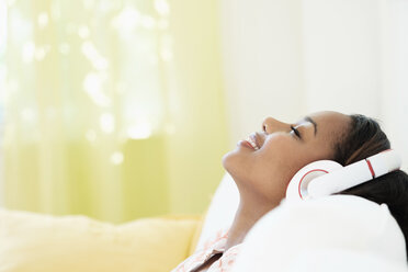 Black woman relaxing listening to headphones - BLEF05217