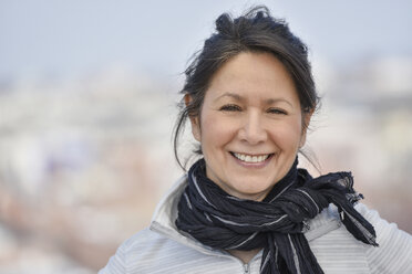 Smiling Hispanic woman wearing scarf - BLEF05226