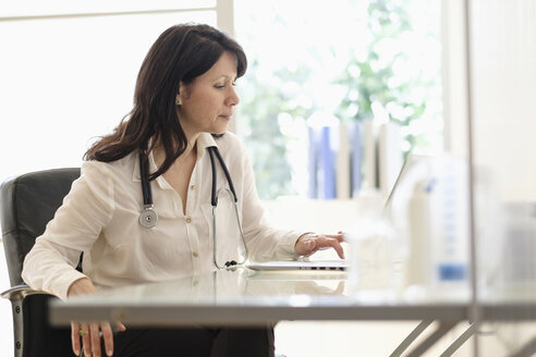 Hispanic doctor using laptop in office - BLEF05236