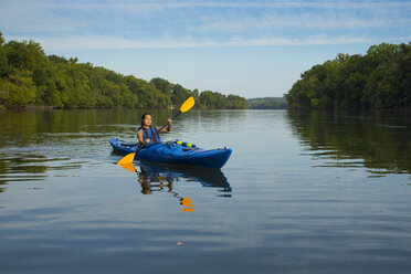 Mixed Race woman kayaking in river - BLEF05273