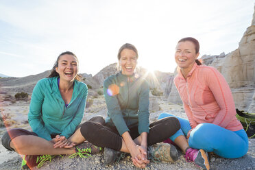 Laughing women sitting in canyon - BLEF05497