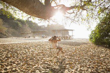 Caucasian girl sitting on tree swing - BLEF05512