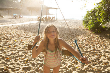 Caucasian girl playing on tree swing - BLEF05513