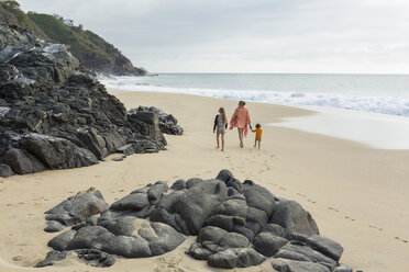 Caucasian mother and children walking on beach - BLEF05530