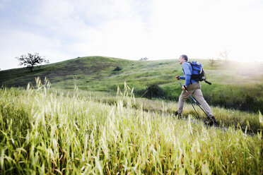 Caucasian man hiking in on mountain path - BLEF05550