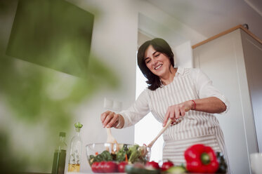 Ältere Frau bereitet Salat in ihrer Küche zu - HAPF02904