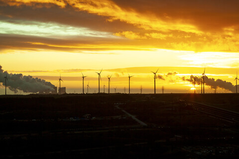 Garzweiler brown coal mining at sunrise with wind park in the background, Juechen, Germany stock photo