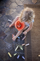 High angle view of girl drawing with chalk on tile - BLEF05645