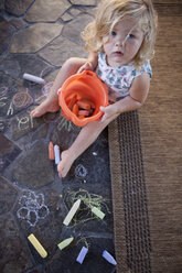 High angle view of girl drawing with chalk on tile - BLEF05646