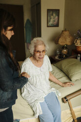 Granddaughter helping grandmother out of bed - BLEF05676