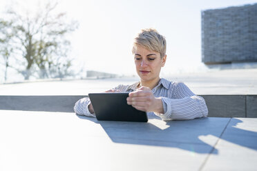 Portrait of young woman using digital tablet - FBAF00604