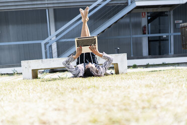 Female ballet dancer in front of an office using laptop lying - ERRF01422