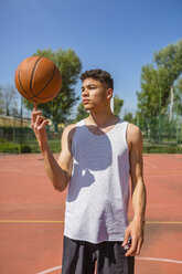 Young man playing with basketball - MGIF00495