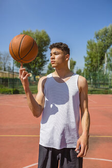 Junger Mann spielt mit Basketball - MGIF00495