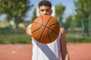 Young man playing basketball, giving the basketball - MGIF00497