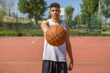 Young man playing basketball, giving the basketball - MGIF00498
