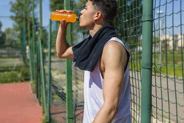 Young basketball player drinking juice - MGIF00504