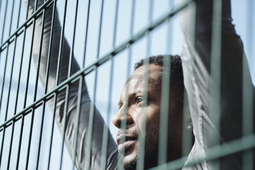 Portrait of sportsman behind fence - AHSF00405