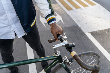 Close-up of casual businessman with bicycle in the city - AFVF03043