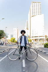 Portrait of smiling casual businessman with bicycle in the city, Barcelona, Spain - AFVF03045