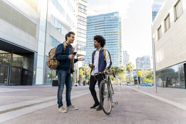 Two casual businessmen meeting in the city, Barcelona, Spain - AFVF03069