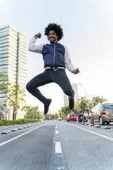 Happy casual man jumping in the city, Barcelona, Spain - AFVF03160